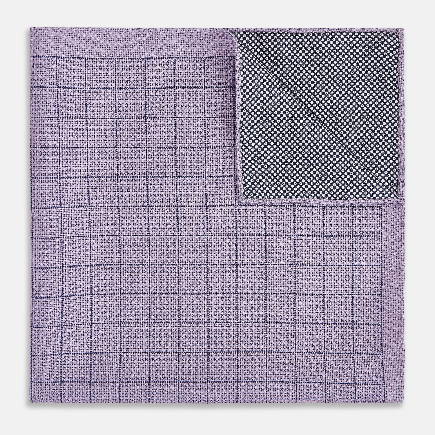 View 4 of product The Checked Lilac Pocket Square in Silk by Turnbull & Asser UK features a grid pattern in purple with a solid border, neatly folded to display its double-sided design and contrasting black and white dotted squares on the reverse side.