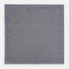 View 6 of product The Checked Lilac Pocket Square in Silk by Turnbull & Asser UK features a grid pattern in purple with a solid border, neatly folded to display its double-sided design and contrasting black and white dotted squares on the reverse side.