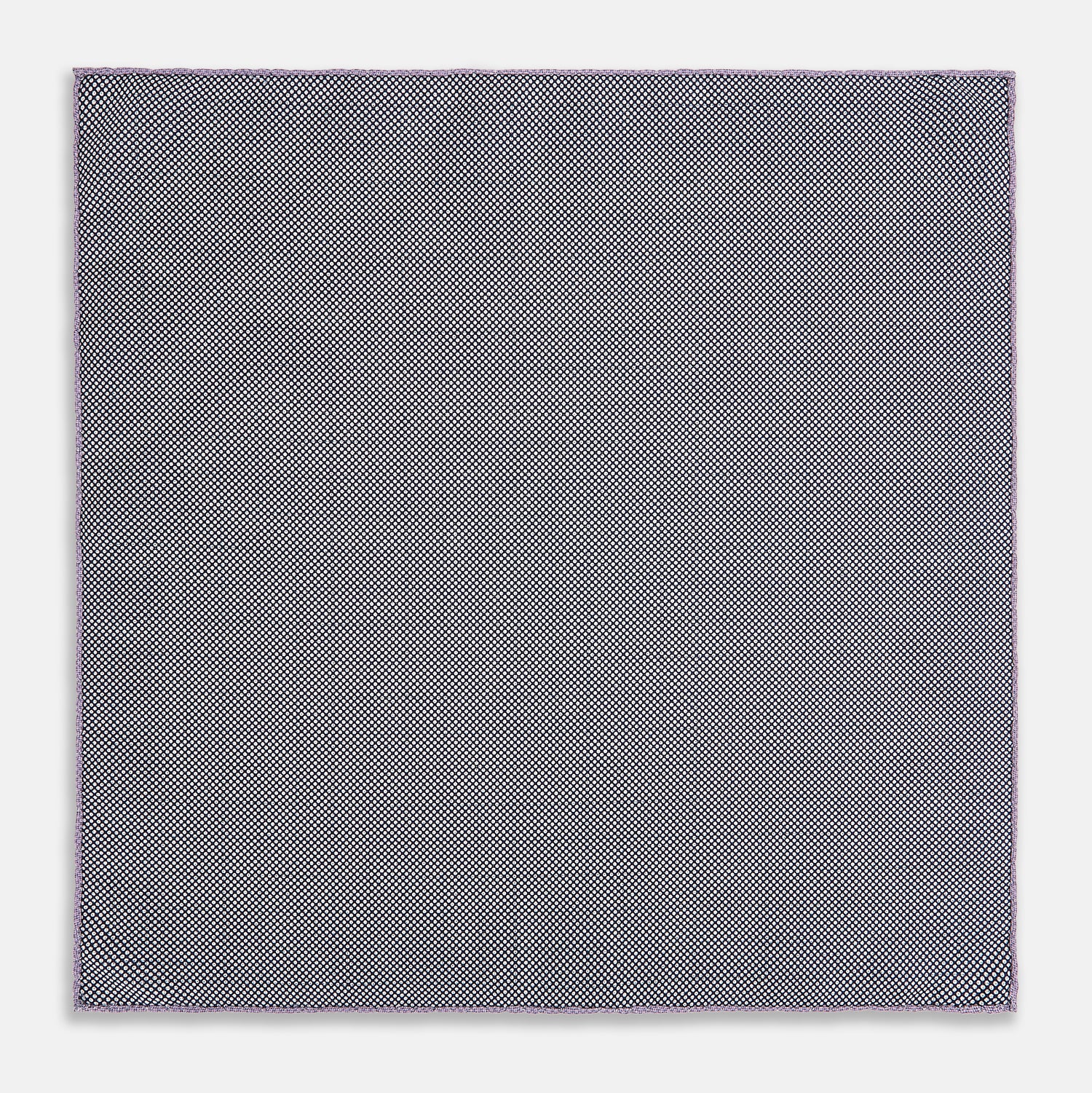 View 6 of product The Checked Lilac Pocket Square in Silk by Turnbull & Asser UK features a grid pattern in purple with a solid border, neatly folded to display its double-sided design and contrasting black and white dotted squares on the reverse side.