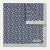 View 2 of product A square silk pocket square from Turnbull & Asser UK, featuring a subtle floral grey pattern; one corner is folded to reveal its double-sided design with a complementary pattern on the reverse side.
