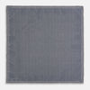 View 6 of product A square silk pocket square from Turnbull & Asser UK, featuring a subtle floral grey pattern; one corner is folded to reveal its double-sided design with a complementary pattern on the reverse side.