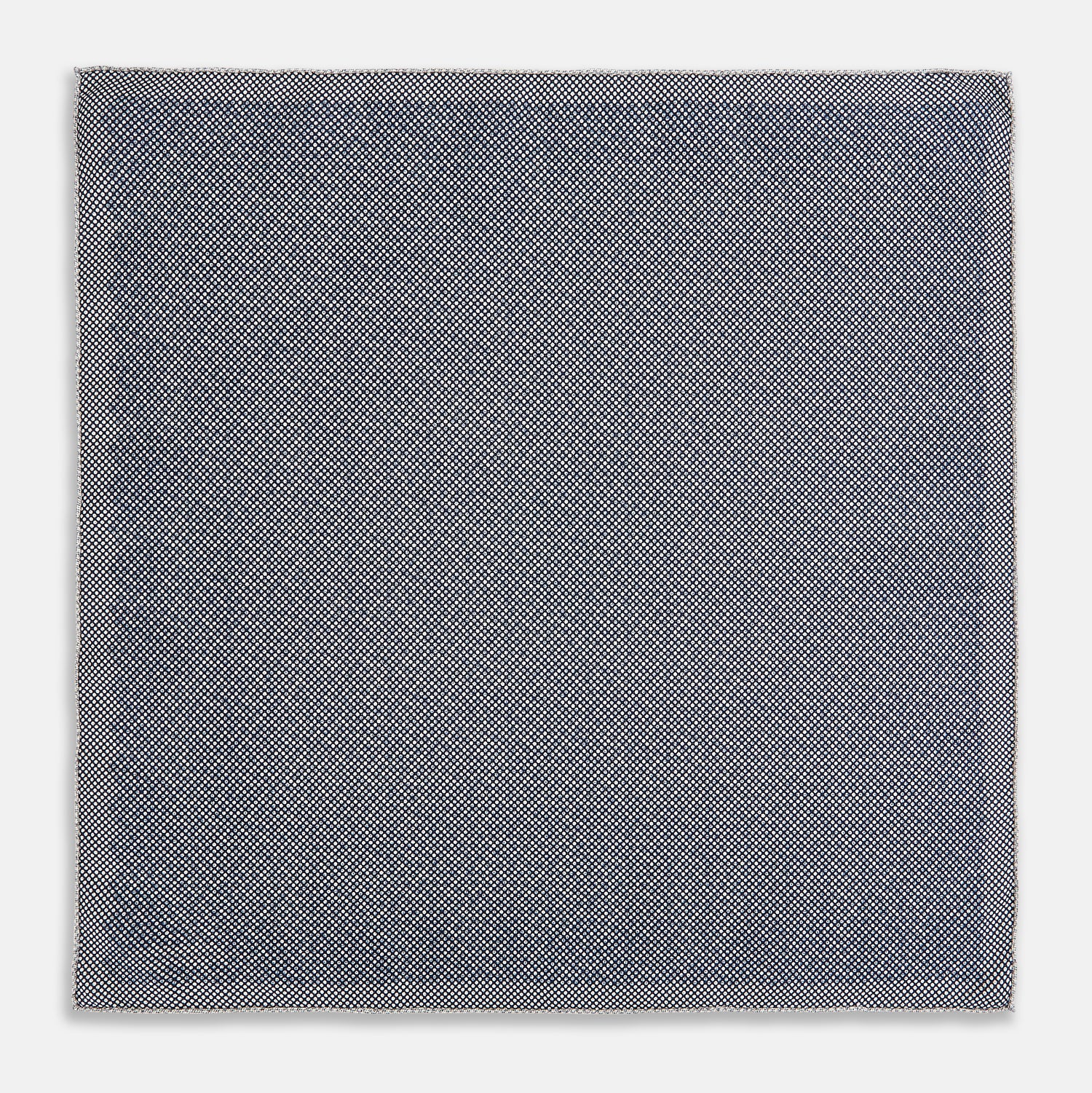 View 6 of product A square silk pocket square from Turnbull & Asser UK, featuring a subtle floral grey pattern; one corner is folded to reveal its double-sided design with a complementary pattern on the reverse side.