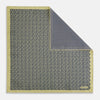 View 3 of product Introducing the Floral Yellow Pocket Square in Silk by Turnbull & Asser UK—a sophisticated square accessory featuring a vibrant yellow border and a black-and-white geometric dot pattern. One corner is tastefully folded to reveal its double-sided design, showcasing a smaller, denser dot motif on the reverse. Perfect for adding a modern touch of flair to any outfit or setting.