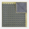 View 4 of product Introducing the Floral Yellow Pocket Square in Silk by Turnbull & Asser UK—a sophisticated square accessory featuring a vibrant yellow border and a black-and-white geometric dot pattern. One corner is tastefully folded to reveal its double-sided design, showcasing a smaller, denser dot motif on the reverse. Perfect for adding a modern touch of flair to any outfit or setting.