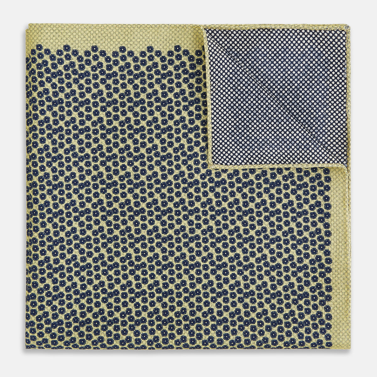 View 4 of product Introducing the Floral Yellow Pocket Square in Silk by Turnbull & Asser UK—a sophisticated square accessory featuring a vibrant yellow border and a black-and-white geometric dot pattern. One corner is tastefully folded to reveal its double-sided design, showcasing a smaller, denser dot motif on the reverse. Perfect for adding a modern touch of flair to any outfit or setting.