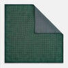 View 3 of product The Geometric Green Tile Pocket Square in Silk by Turnbull & Asser UK features a sophisticated tonal green design with a subtle pattern of concentric squares. One corner is folded to highlight the elegant double-sided construction, revealing a contrasting black and white small dot pattern on the reverse.