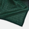 View 2 of product The Geometric Green Tile Pocket Square in Silk by Turnbull & Asser UK features a sophisticated tonal green design with a subtle pattern of concentric squares. One corner is folded to highlight the elegant double-sided construction, revealing a contrasting black and white small dot pattern on the reverse.