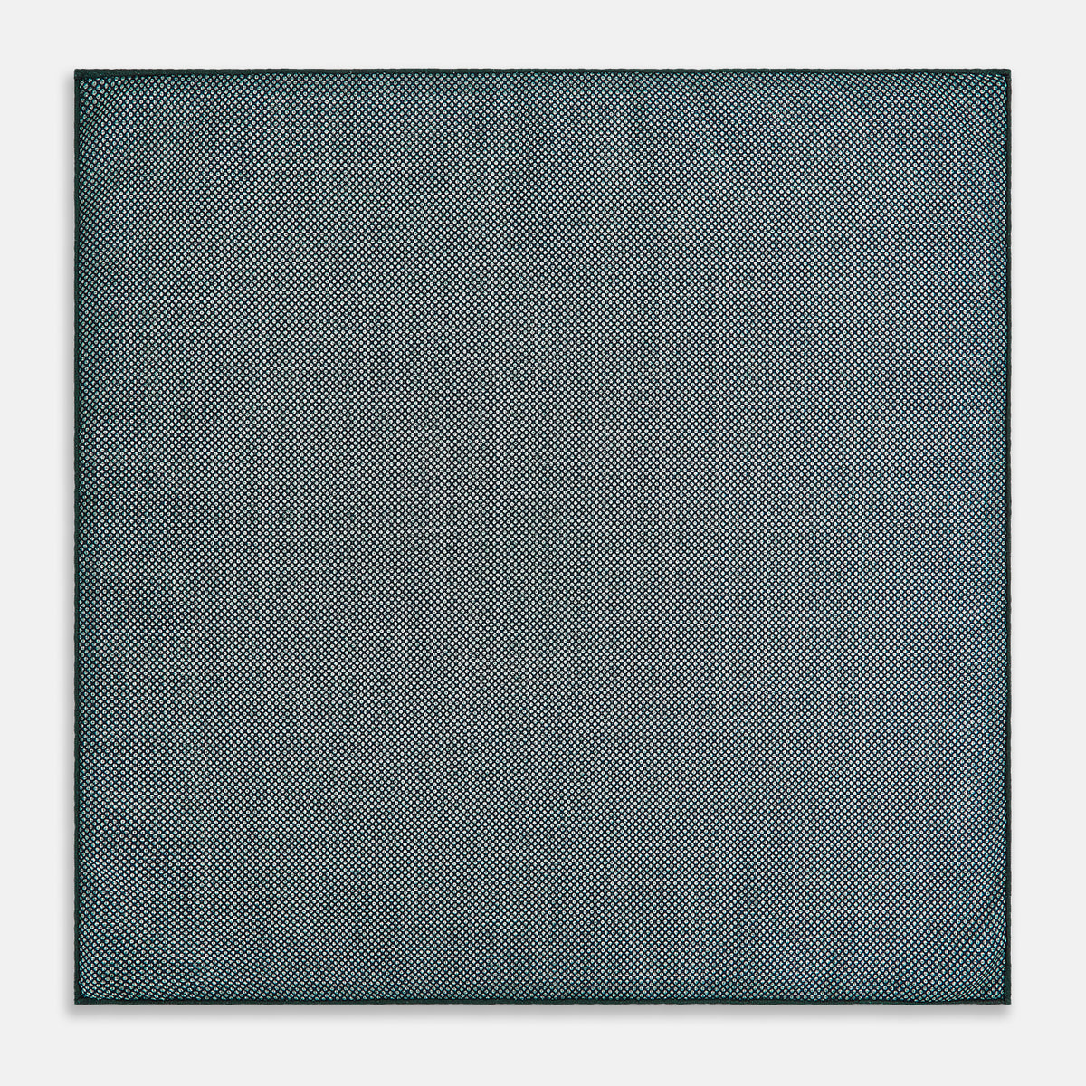View 6 of product The Geometric Green Tile Pocket Square in Silk by Turnbull & Asser UK features a sophisticated tonal green design with a subtle pattern of concentric squares. One corner is folded to highlight the elegant double-sided construction, revealing a contrasting black and white small dot pattern on the reverse.