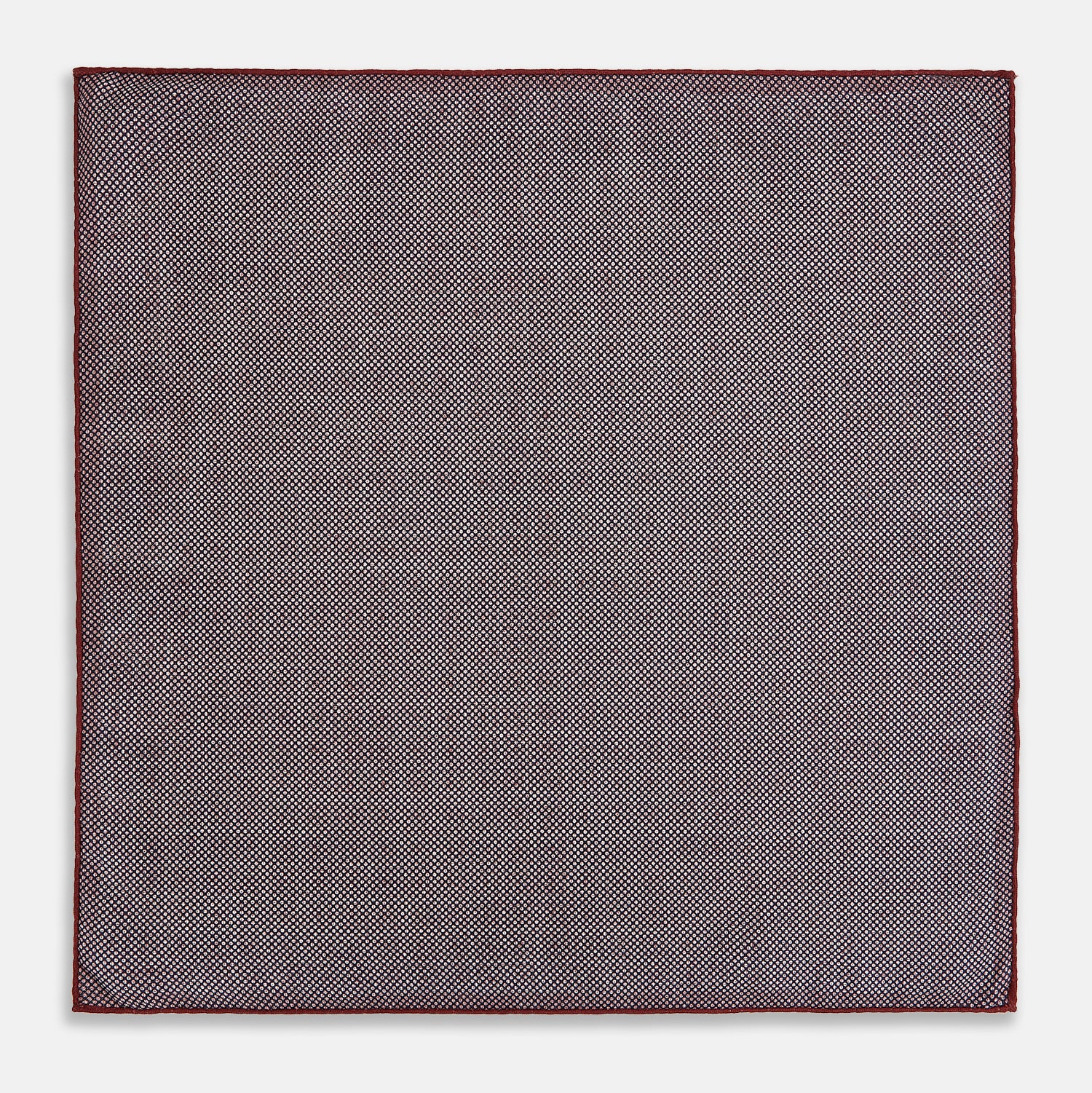 View 6 of product The Turnbull & Asser UK Geometric Burgundy Tile Pocket Square in Silk is displayed partly folded, showcasing its bold geometric grid pattern with concentric burgundy squares on the front and a contrasting black-and-white dotted design on the reverse.