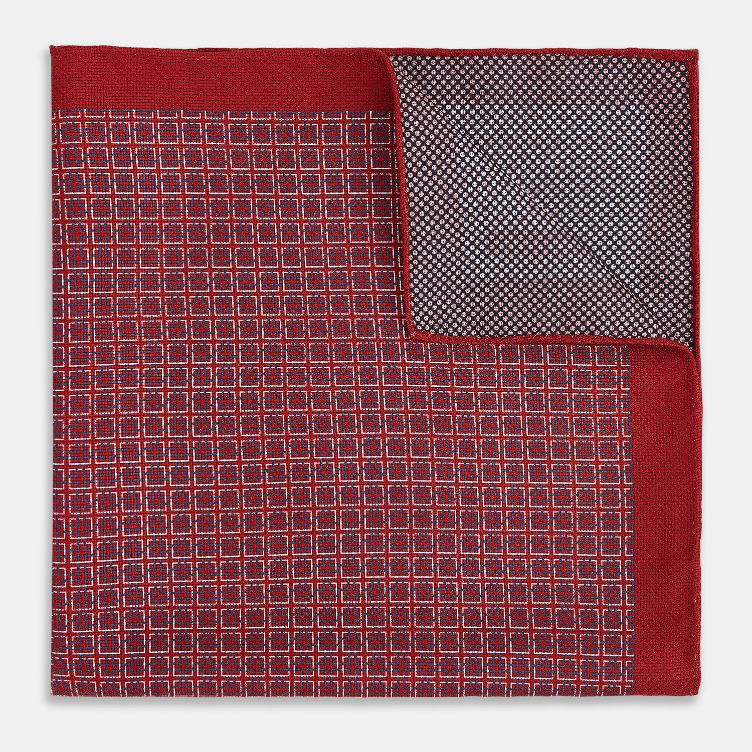 View 4 of product Turnbull & Asser UK’s Geometric Red Pocket Square in Silk features a small white checkered pattern and a cleverly flipped corner to showcase its contrasting black and white micro-dot reverse design.