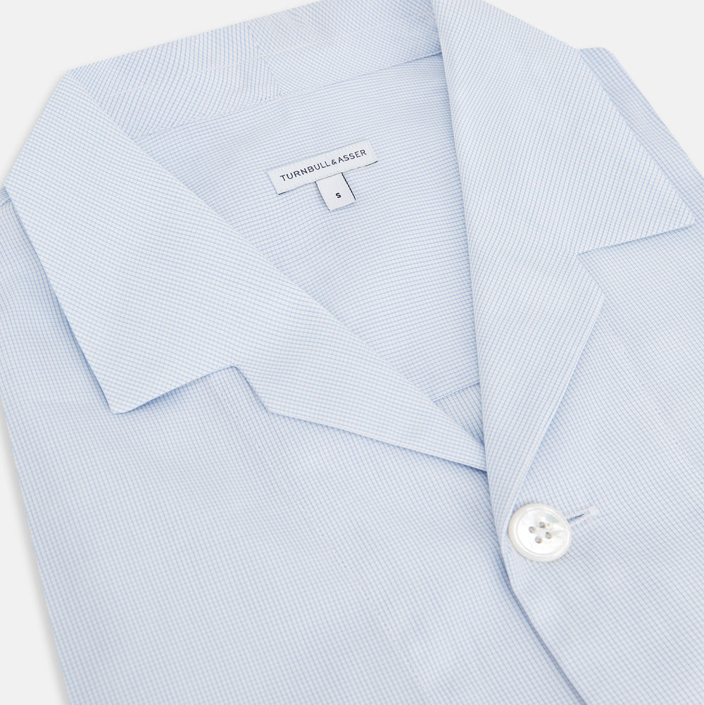 The Turnbull & Asser Pale Blue Fine Micro Check Pyjama Shirt features long sleeves, a notched collar, and a chest pocket—styled flat on white, ideal for elegant nightwear.