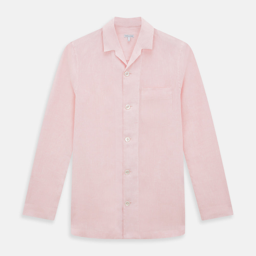 The Turnbull & Asser Pale Pink Linen Pyjama Shirt features long sleeves, a chest pocket, and a classic button-up design—ideal for stylish nightwear or relaxed homewear. Shown laid flat on a white background.