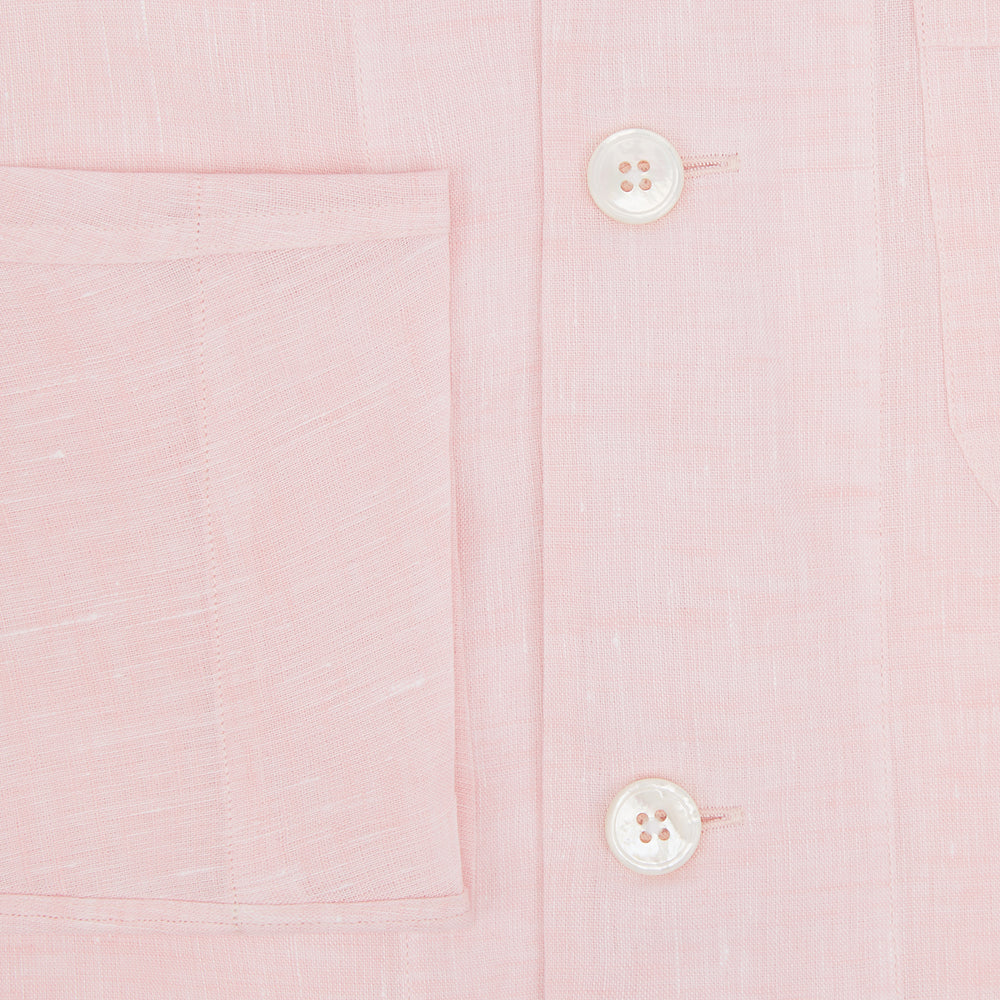 The Turnbull & Asser Pale Pink Linen Pyjama Shirt features long sleeves, a chest pocket, and a classic button-up design—ideal for stylish nightwear or relaxed homewear. Shown laid flat on a white background.