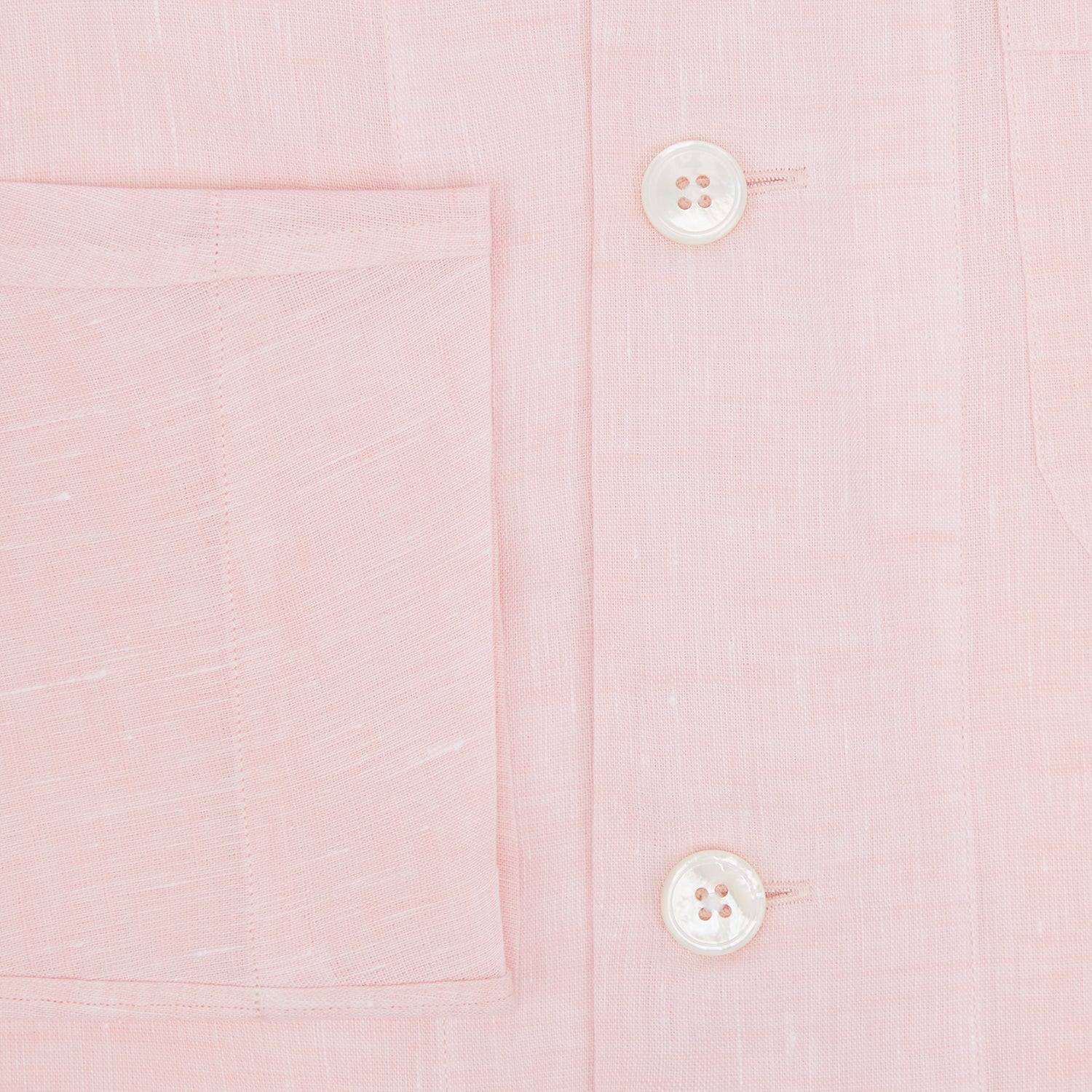View 4 of product The Turnbull & Asser Pale Pink Linen Pyjama Shirt features long sleeves, a chest pocket, and a classic button-up design—ideal for stylish nightwear or relaxed homewear. Shown laid flat on a white background.