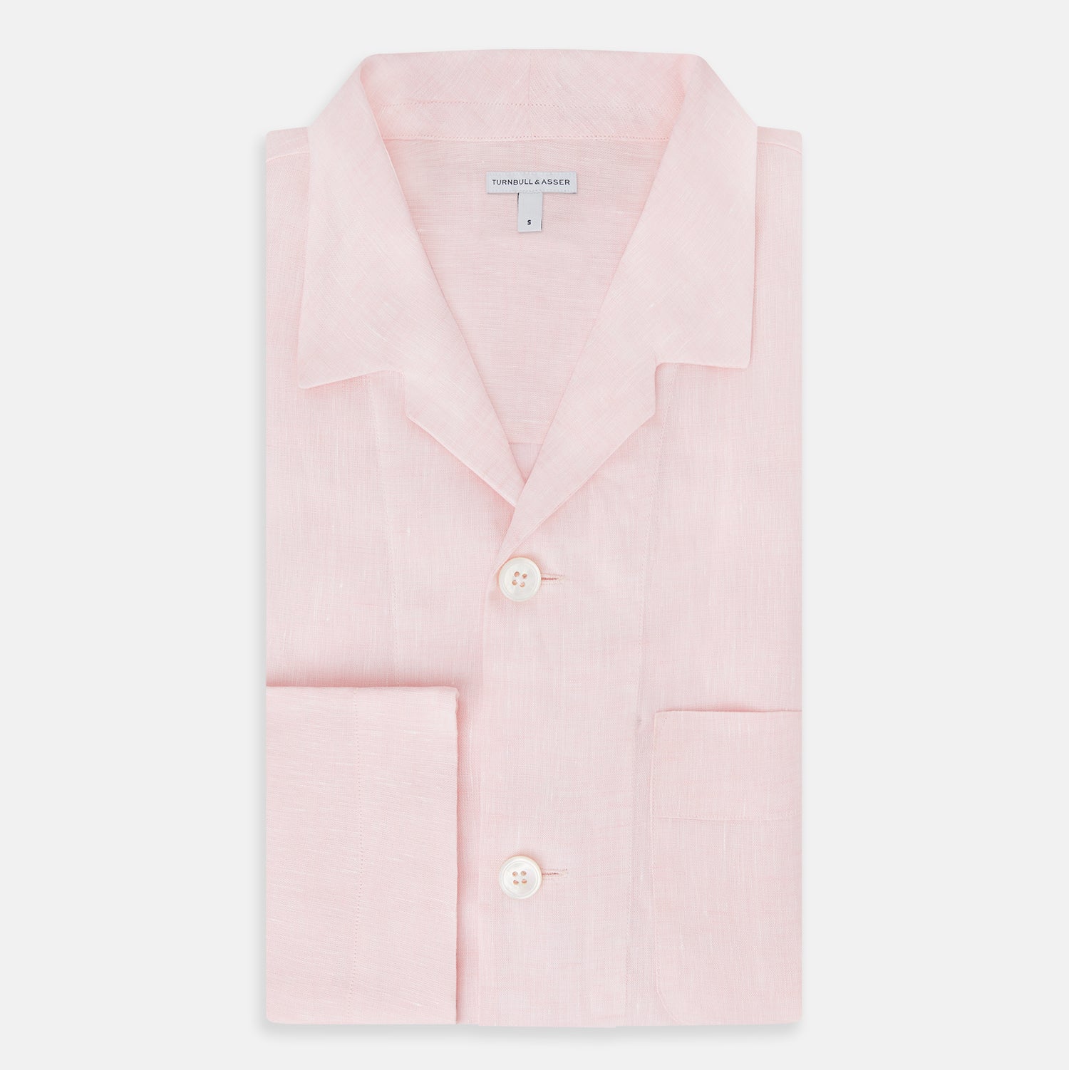 View 5 of product The Turnbull & Asser Pale Pink Linen Pyjama Shirt features long sleeves, a chest pocket, and a classic button-up design—ideal for stylish nightwear or relaxed homewear. Shown laid flat on a white background.