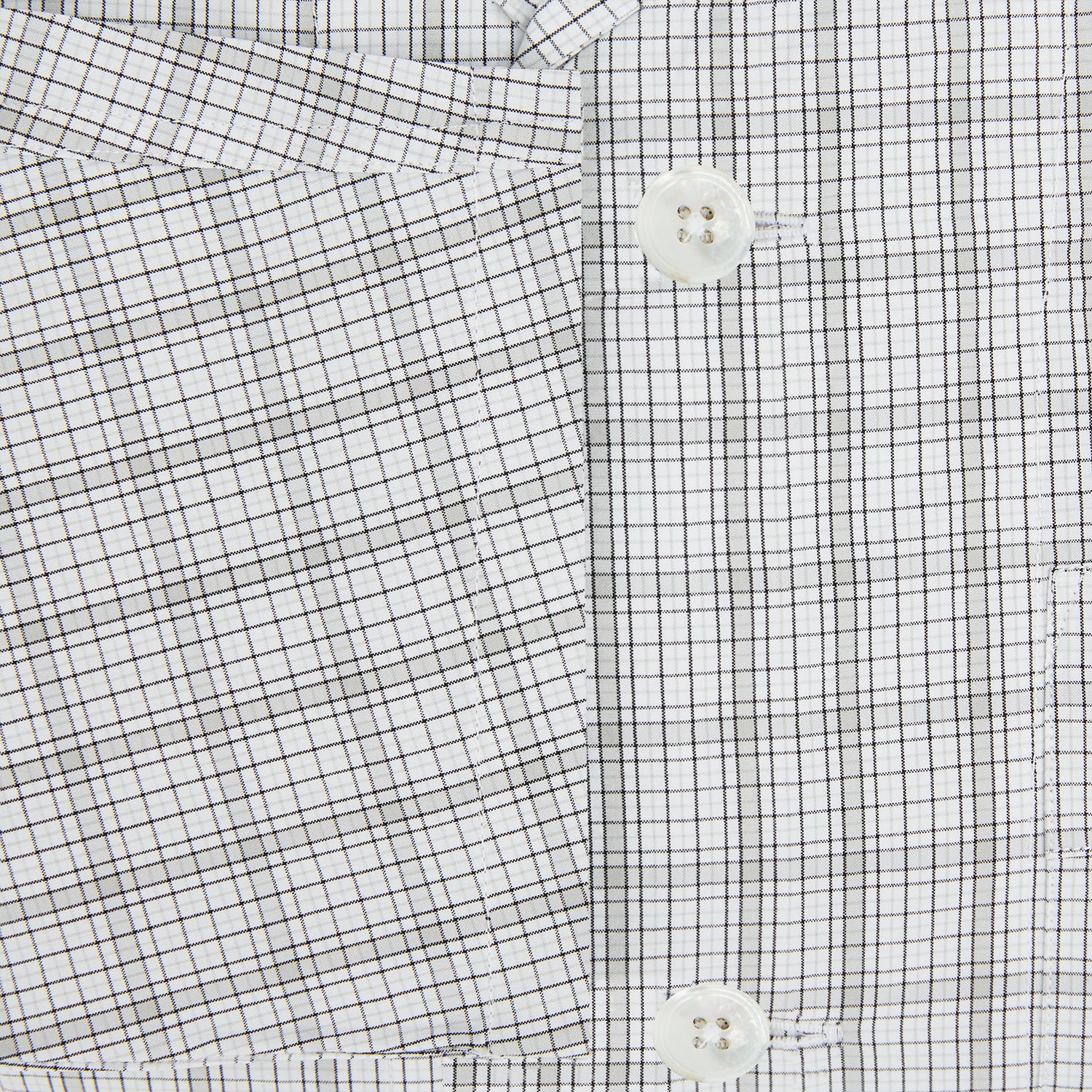 View 4 of product The Turnbull & Asser Grey Fine Multi Graph Check Pyjama Shirt features light grey and white checks, a single chest pocket, and long sleeves—ideal for stylish nightwear or as a classic pyjama shirt. Shown on a white background.