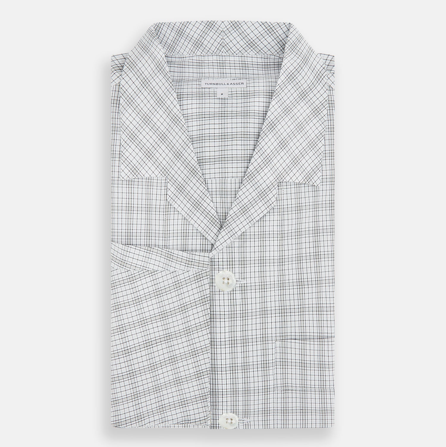 View 5 of product The Turnbull & Asser Grey Fine Multi Graph Check Pyjama Shirt features light grey and white checks, a single chest pocket, and long sleeves—ideal for stylish nightwear or as a classic pyjama shirt. Shown on a white background.