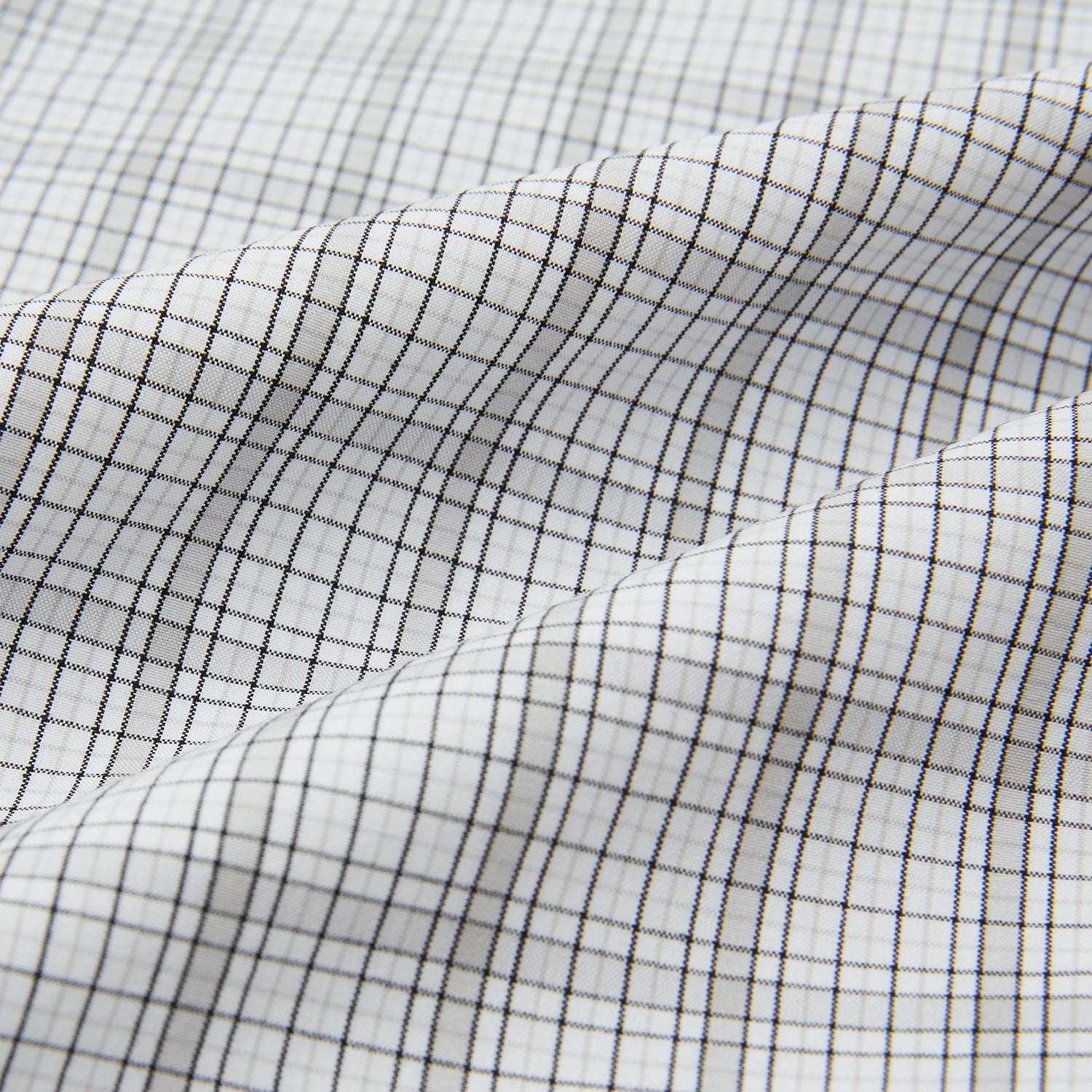 View 6 of product The Turnbull & Asser Grey Fine Multi Graph Check Pyjama Shirt features light grey and white checks, a single chest pocket, and long sleeves—ideal for stylish nightwear or as a classic pyjama shirt. Shown on a white background.