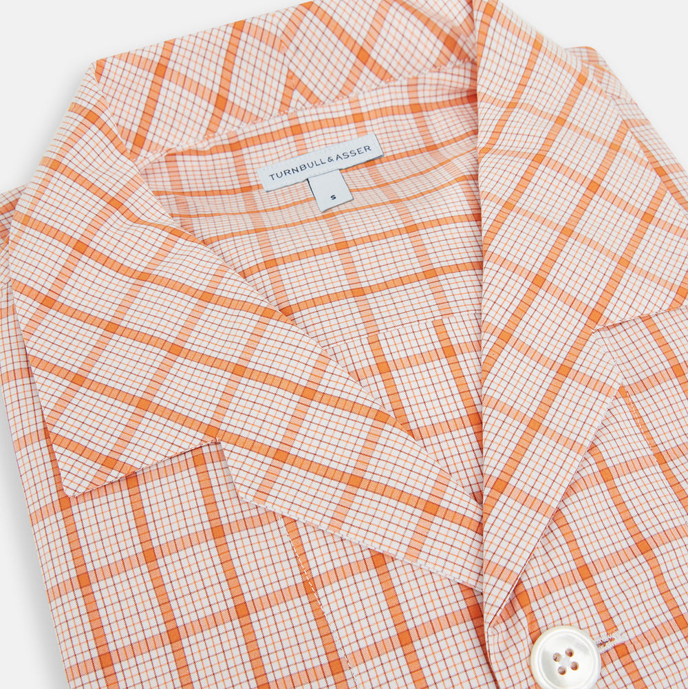 The Orange Graph Overlay Check Pyjama Shirt by Turnbull & Asser features long sleeves, a notched collar, and a front chest pocket, shown here laid flat on a white background.