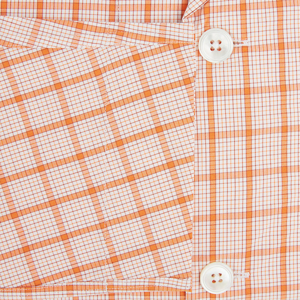 The Orange Graph Overlay Check Pyjama Shirt by Turnbull & Asser features long sleeves, a notched collar, and a front chest pocket, shown here laid flat on a white background.