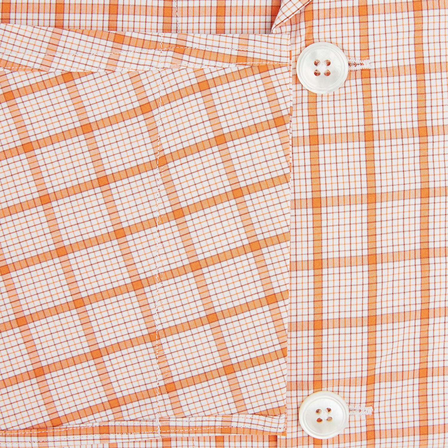 View 4 of product The Orange Graph Overlay Check Pyjama Shirt by Turnbull & Asser features long sleeves, a notched collar, and a front chest pocket, shown here laid flat on a white background.