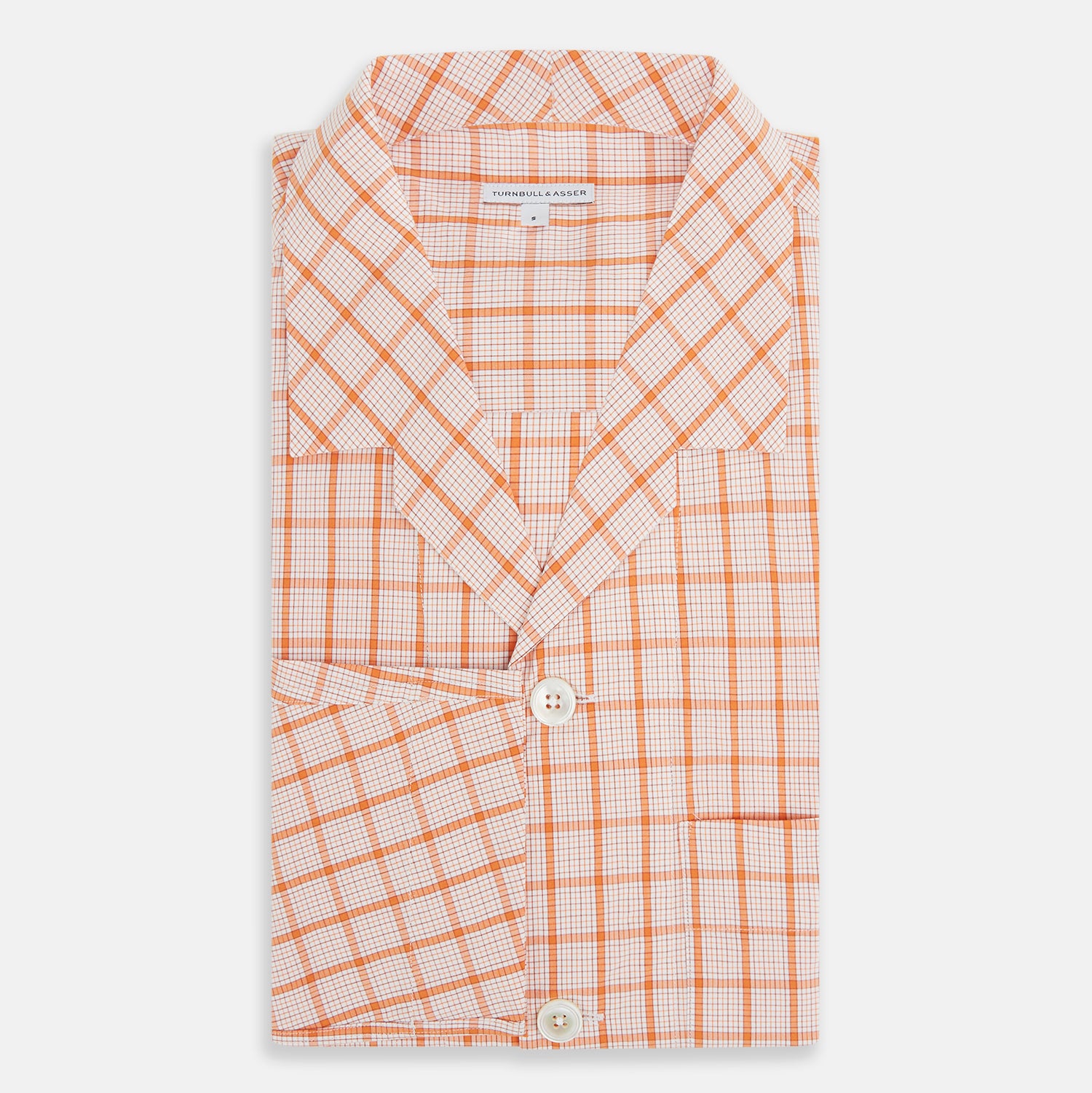 View 5 of product The Orange Graph Overlay Check Pyjama Shirt by Turnbull & Asser features long sleeves, a notched collar, and a front chest pocket, shown here laid flat on a white background.