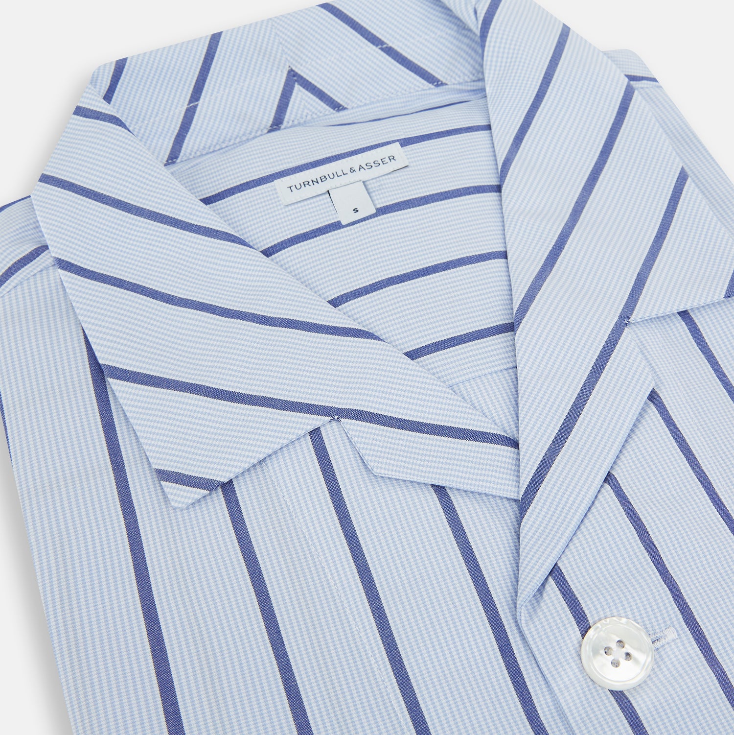 View 2 of product The Turnbull & Asser Blue Track Stripe Pyjama Shirt features a collar, white buttons, chest pocket, and vertical navy stripes—an elegant and comfortable loungewear option perfect for stylish nightwear.