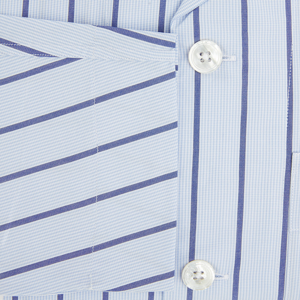 The Turnbull & Asser Blue Track Stripe Pyjama Shirt features a collar, white buttons, chest pocket, and vertical navy stripes—an elegant and comfortable loungewear option perfect for stylish nightwear.