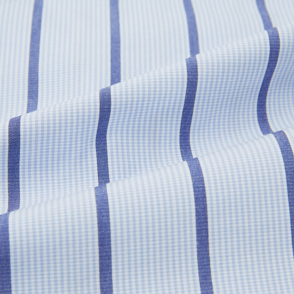 The Turnbull & Asser Blue Track Stripe Pyjama Shirt features a collar, white buttons, chest pocket, and vertical navy stripes—an elegant and comfortable loungewear option perfect for stylish nightwear.