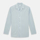 The Turnbull & Asser Light Green and Blue Stripe Pyjama Shirt features long sleeves, a front chest pocket, and elegant loungewear style, shown on a plain white background.