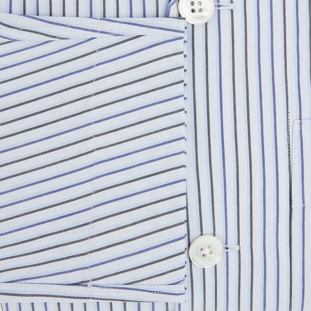 The Turnbull & Asser Blue Shadow Pinstripe Pyjama Shirt features blue and white vertical stripes, a chest pocket, and long sleeves—ideal for elegant homewear, shown against a white background.