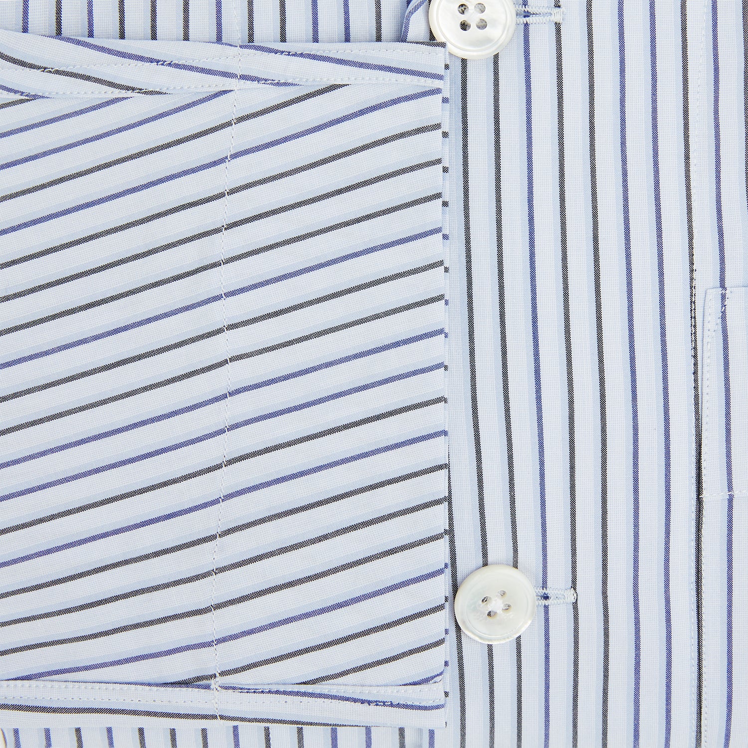 View 4 of product The Turnbull & Asser Blue Shadow Pinstripe Pyjama Shirt features blue and white vertical stripes, a chest pocket, and long sleeves—ideal for elegant homewear, shown against a white background.