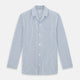 The Turnbull & Asser Blue Shadow Pinstripe Pyjama Shirt features blue and white vertical stripes, a chest pocket, and long sleeves—ideal for elegant homewear, shown against a white background.