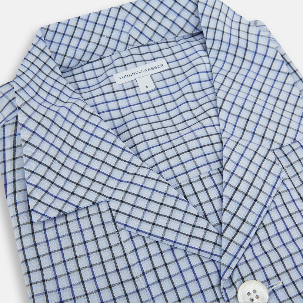 The Turnbull & Asser Blue Shadow Check Pyjama Shirt features long sleeves, a button-up front, collar, and chest pocket—ideal for refined loungewear or stylish nightwear.