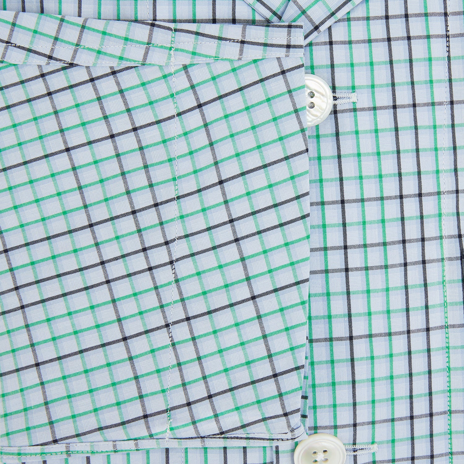 View 4 of product The Turnbull & Asser Green and Blue Shadow Check Pyjama Shirt, with a collar and chest pocket, is perfect loungewear or nightwear; shown laid flat on a white background.