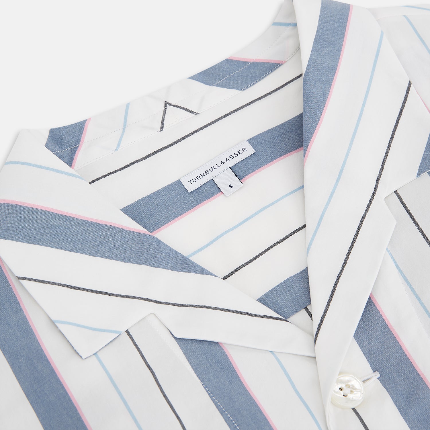 View 2 of product The Turnbull & Asser Blue Blazer Stripe Pyjama Shirt features a collar, chest pocket, and vertical blue, white, and light red stripes—an elegant long-sleeve loungewear piece neatly displayed on a plain white background.