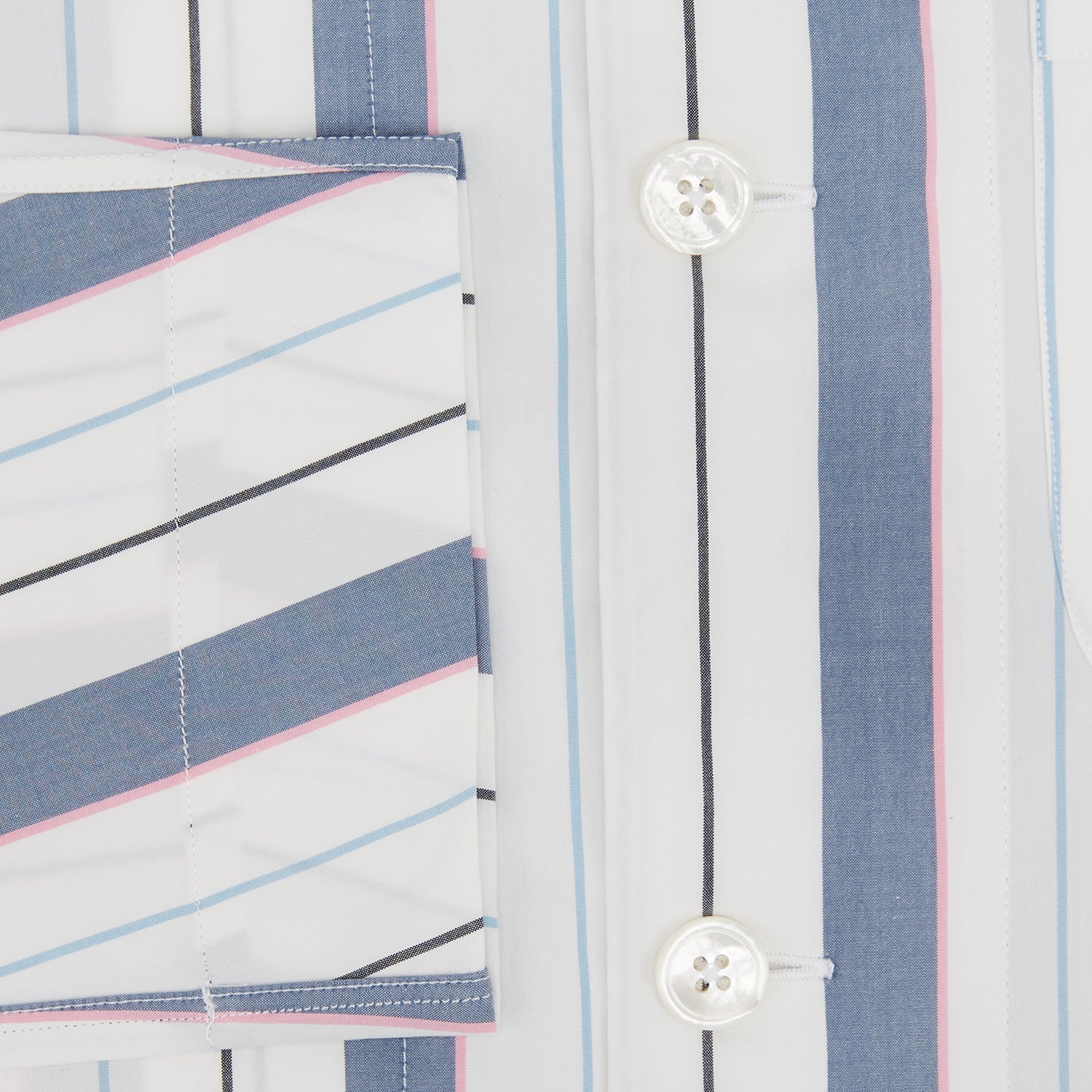 View 4 of product The Turnbull & Asser Blue Blazer Stripe Pyjama Shirt features a collar, chest pocket, and vertical blue, white, and light red stripes—an elegant long-sleeve loungewear piece neatly displayed on a plain white background.
