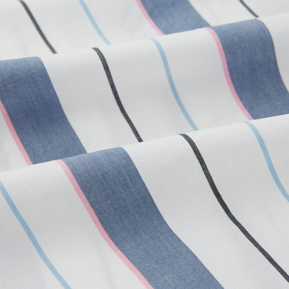 The Turnbull & Asser Blue Blazer Stripe Pyjama Shirt features a collar, chest pocket, and vertical blue, white, and light red stripes—an elegant long-sleeve loungewear piece neatly displayed on a plain white background.