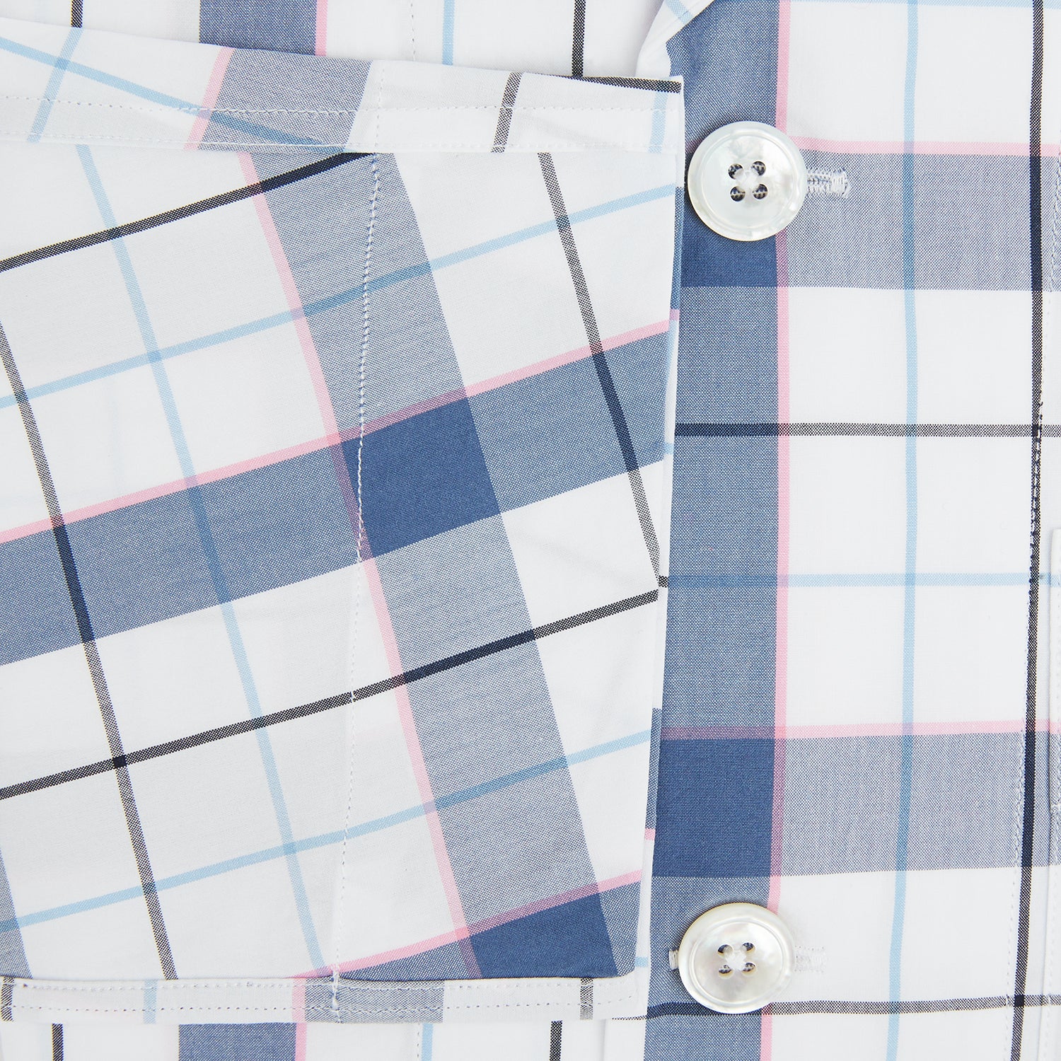 View 4 of product The Turnbull & Asser Blue Blazer Check Pyjama Shirt features long sleeves, a classic collar, and white buttons in a blue and white plaid, offering elegant loungewear style.