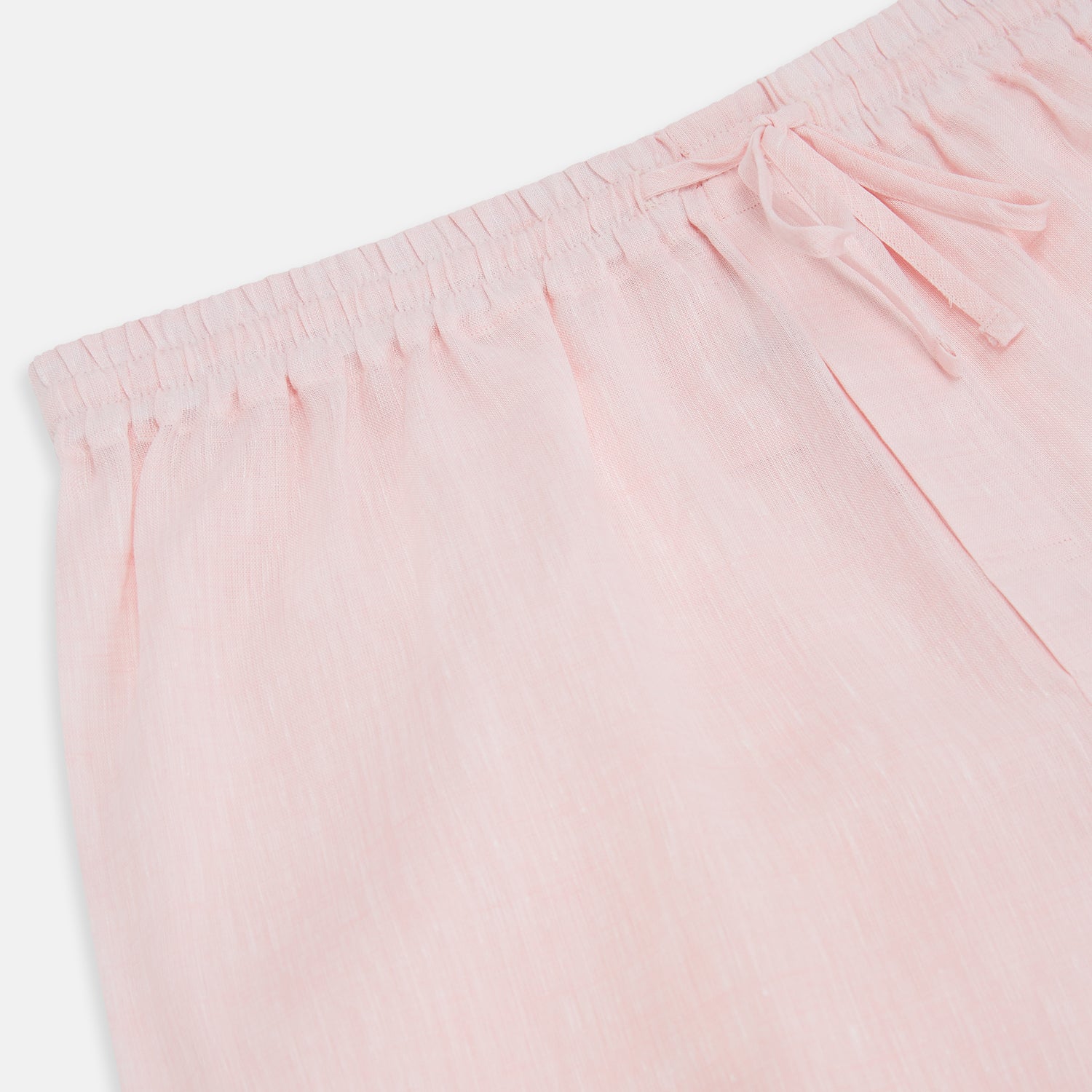 View 2 of product The Turnbull & Asser Pale Pink Linen Pyjama Trousers feature an elastic waistband and drawstring, combining comfort and style. Displayed flat on a plain white background, these trousers are perfect sleepwear.