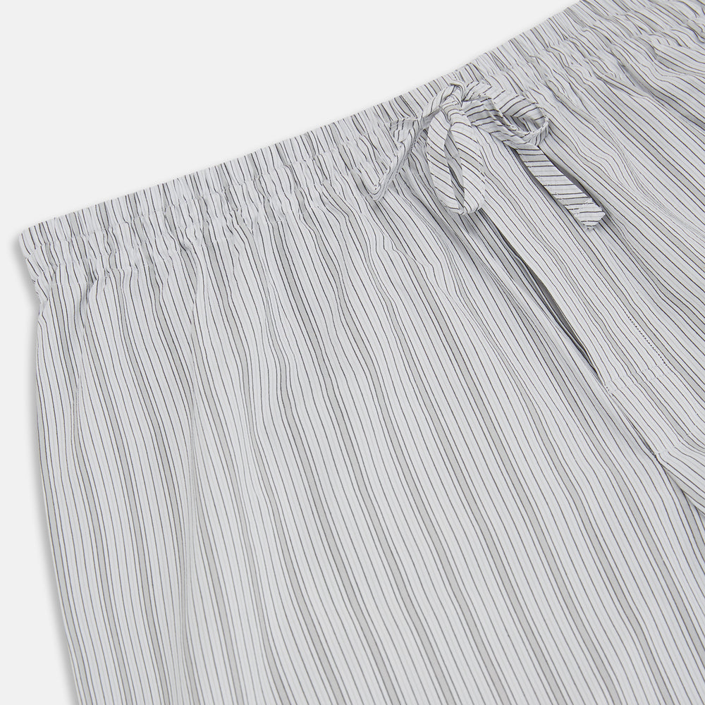 Turnbull & Asser’s Grey Fine Track Stripe Pyjama Trousers feature vertical white pinstripes, a relaxed fit, and an elastic drawstring waistband—ideal for comfortable sleepwear.