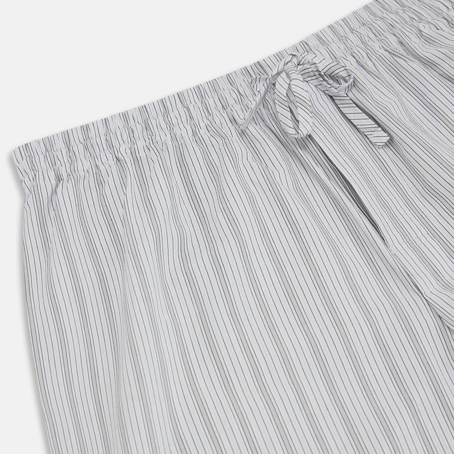 View 2 of product Turnbull & Asser’s Grey Fine Track Stripe Pyjama Trousers feature vertical white pinstripes, a relaxed fit, and an elastic drawstring waistband—ideal for comfortable sleepwear.