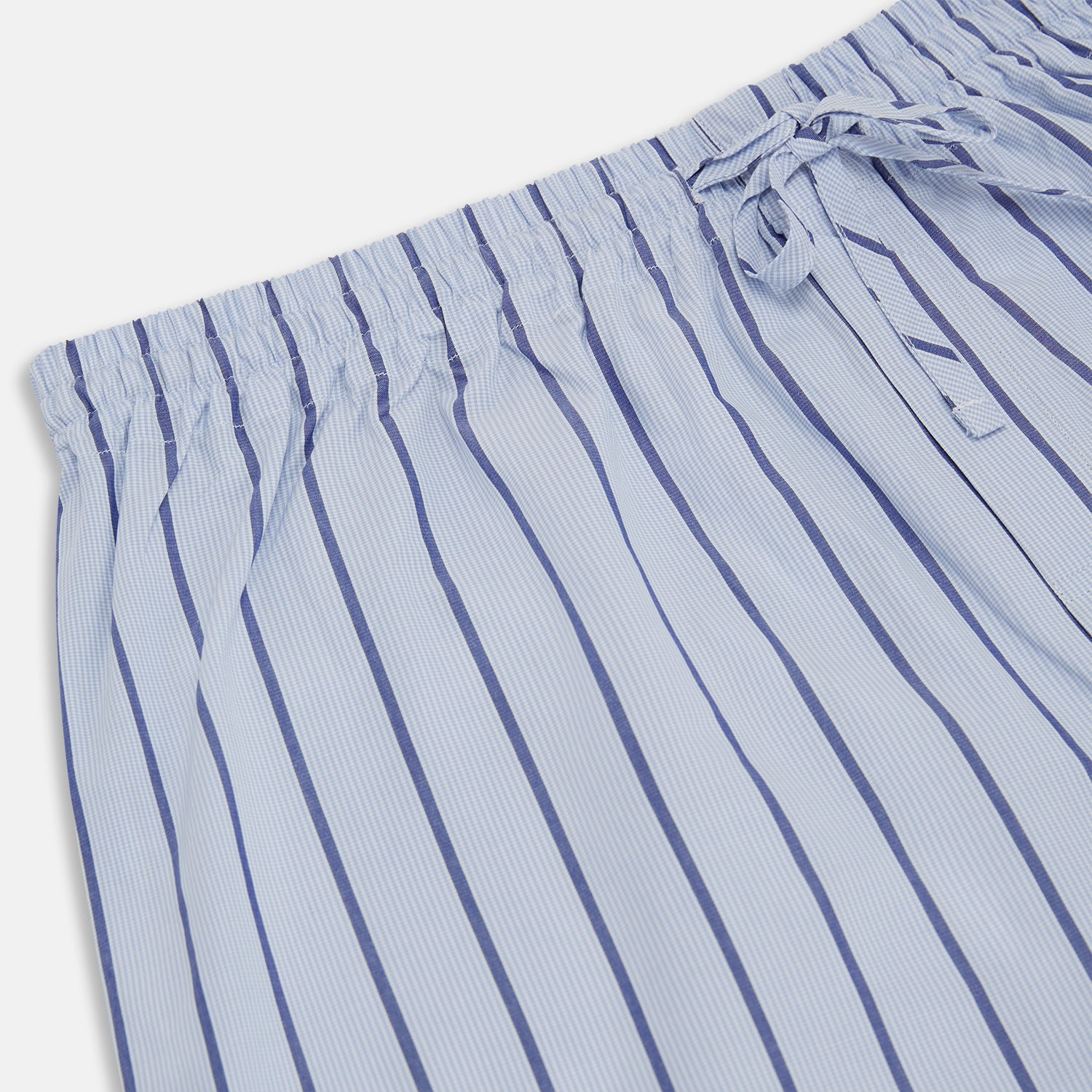 View 2 of product Turnbull & Asser Blue Track Stripe Pyjama Trousers in light blue cotton with dark blue vertical pinstripes and a drawstring waist, shown laid flat on a white background.