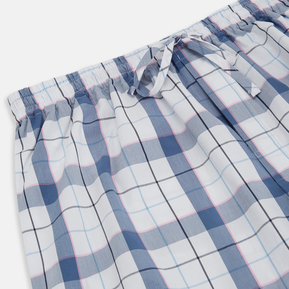 The Blue Blazer Check Pyjama Trousers by Turnbull & Asser feature a straight-leg fit, elastic waistband with drawstring, and white, blue, and gray plaid pattern. Comfortable with side pockets, they are shown laid flat against a white background.