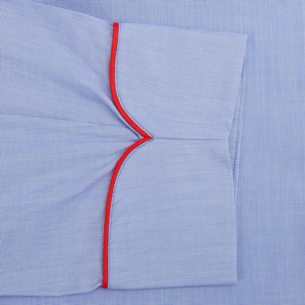 The Turnbull & Asser Light Blue Piped End-On-End Cotton Gown features a belted waist, three front pockets, and red piping on the collar, pockets, and cuffs—ideal for travel. Displayed against a white background.