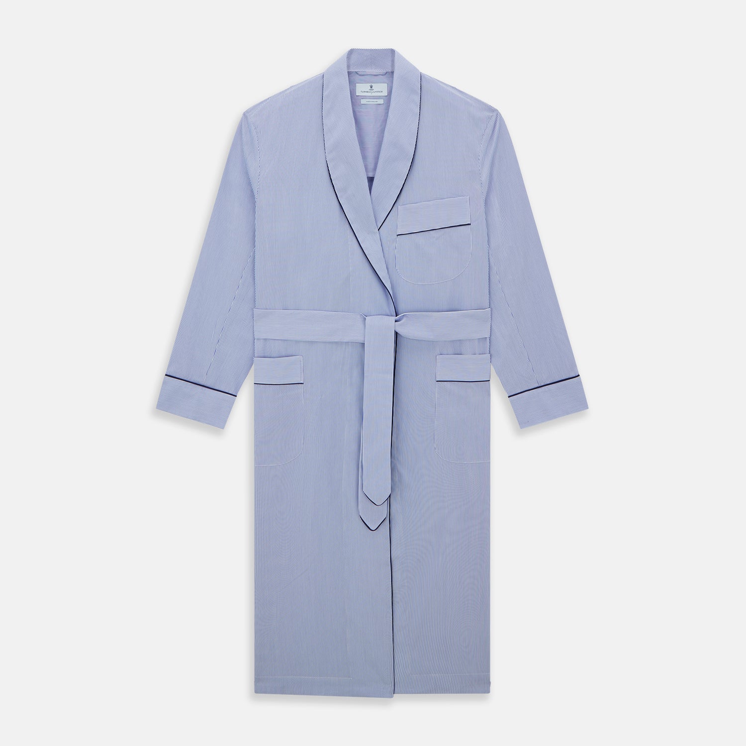 View 1 of product The Blue Fine Bengal Stripe Piped Cotton Gown by Turnbull & Asser features long sleeves, a shawl collar, navy piping, three pockets, and a fabric belt—ideal for those who appreciate classic cotton dressing gowns.