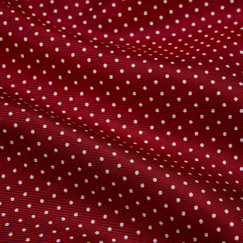 The Turnbull & Asser Burgundy Spot Silk Gown features a shawl collar, front pocket, and matching belt—ideal for relaxation—shown on a white background.