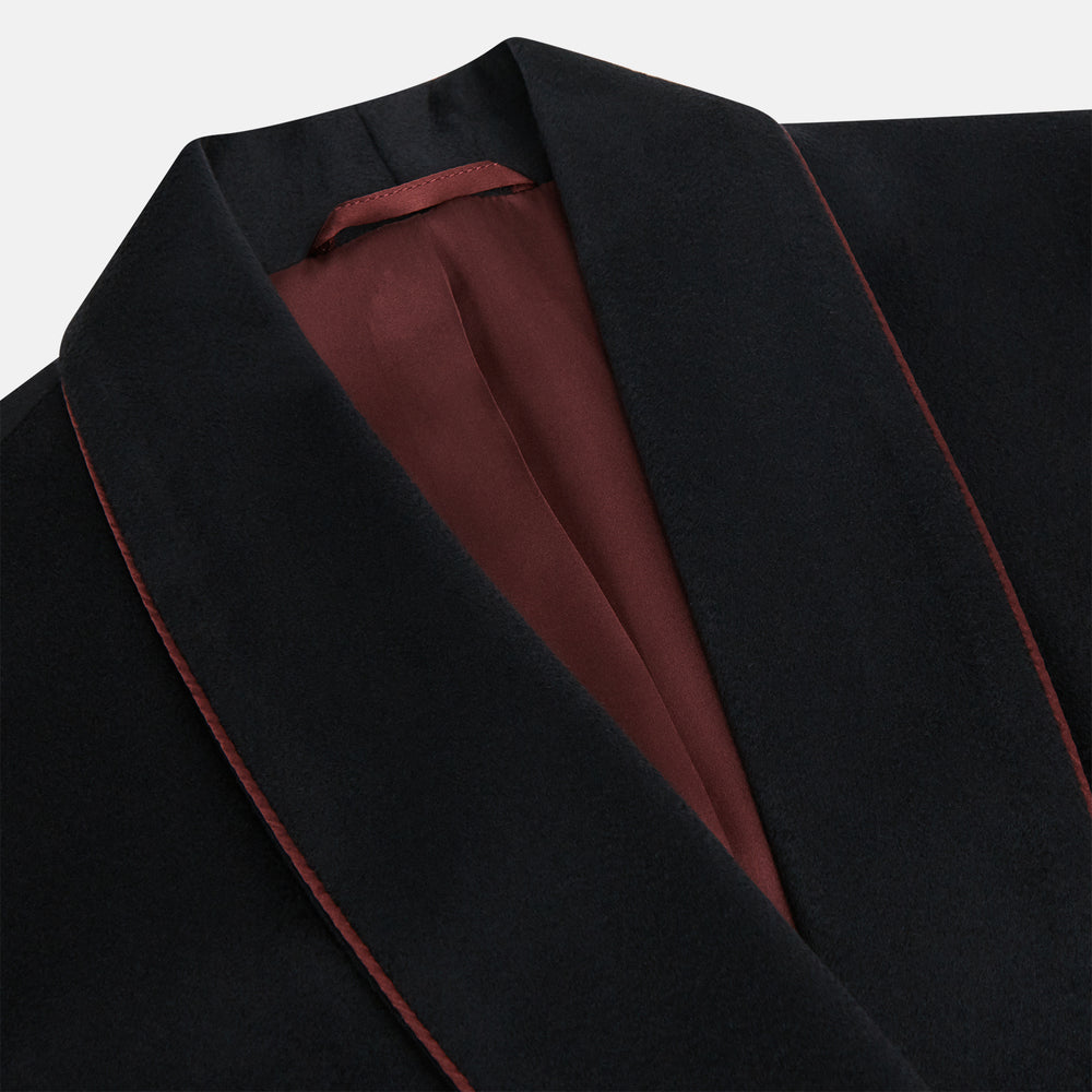 The Navy and Red Piped Cashmere Gown by Turnbull & Asser features a belted navy silhouette with red contrast piping, wide lapels, chest pocket, and two side pockets, shown on a plain white background.