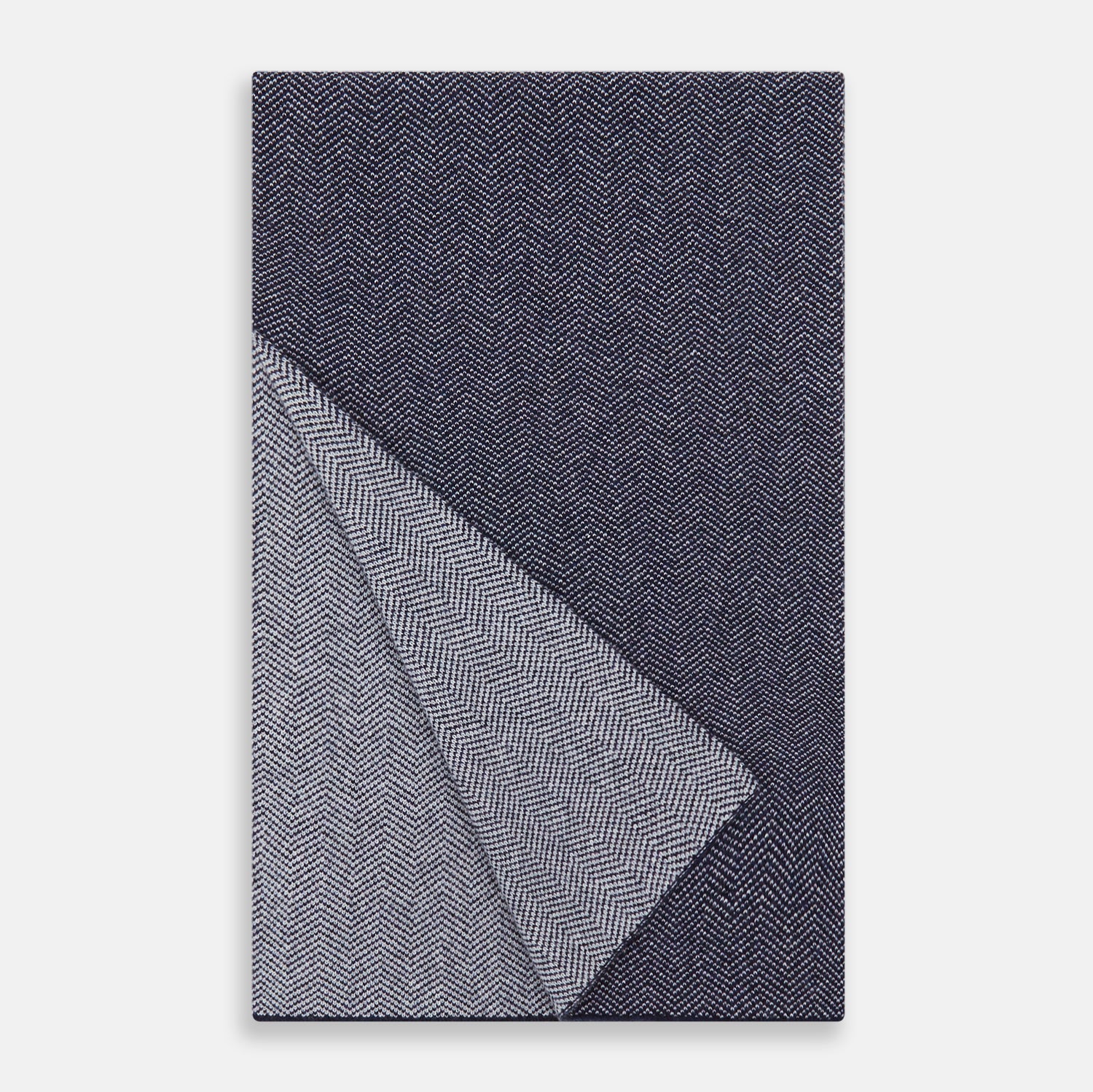 View 2 of product The Turnbull & Asser Reversible Navy and White Herringbone Cashmere Scarf is a timeless winter accessory, featuring an elegant two-tone pattern and luxurious softness.
