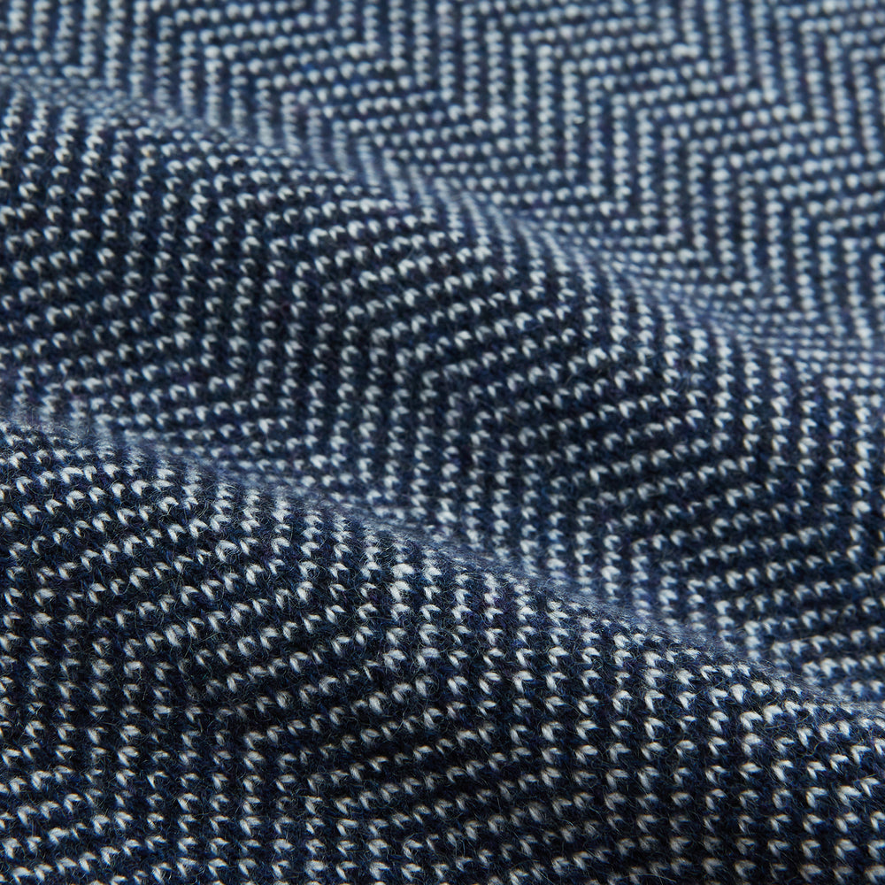 The Turnbull & Asser Reversible Navy and White Herringbone Cashmere Scarf is a timeless winter accessory, featuring an elegant two-tone pattern and luxurious softness.